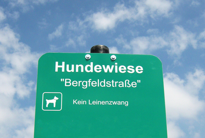 Bild eines Schildes mit dem Hinweis Hundewiese Bergfeldstraße Kein Leinenzwang